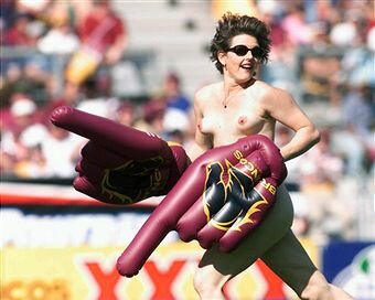A streaker runs across the field moments before the start of the round 22 NRL match between the Brisbane Broncos and the Sydney Roosters played in Australia.